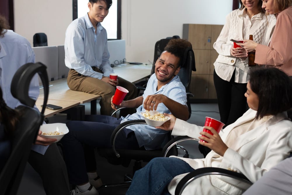 NDIS participant in a wheelchair collaborating with support team on work and life skills in an inclusive environment, promoting independence and community participation.