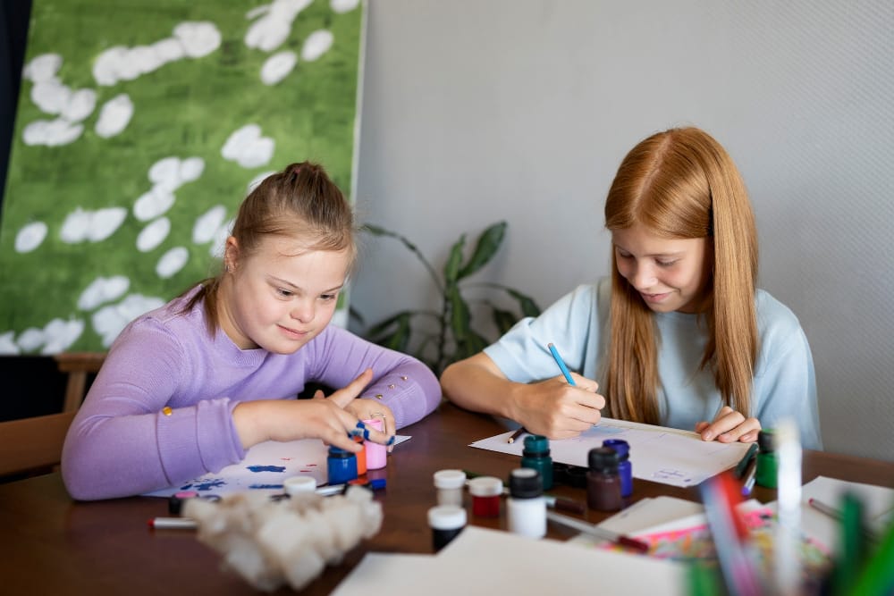 NDIS participants engaging in creative art activities together, developing life skills, social interaction, and confidence through supported community participation.